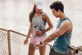 Couple checking performance on fitness device